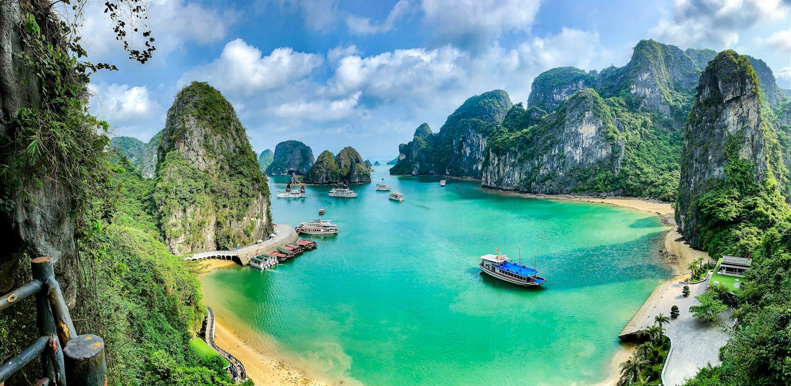 Boats on the turquoise water of Ha Long Bay among limestone karst islands